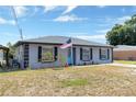 Exterior shot of charming single-story home featuring well-maintained landscaping at 152 Harrison St, Lake Wales, FL 33859