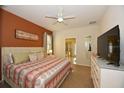 Large bedroom with king-size bed, TV, and ensuite bathroom access at 2112 Morocco Way, Kissimmee, FL 34747