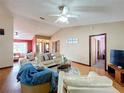 Bright living room features vaulted ceilings, wood floors, and comfortable seating area, perfect for relaxation at 3039 China Berry Ct, Kissimmee, FL 34746