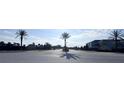 Community entrance featuring lush landscaping, palm trees, and clear signage under a bright sky at 361 Annabelle Way, Davenport, FL 33837