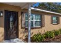 Close-up of the home's entrance, showing the front door, shutters, and house number at 3827 Anna Dr, Apopka, FL 32703