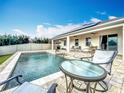 Inviting backyard pool with a patio and outdoor seating, perfect for relaxation and entertaining guests at 3857 San Isidro Cir, St Cloud, FL 34772