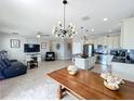 Open concept living area with kitchen, tile floors, modern lighting, and comfortable seating arrangements at 3857 San Isidro Cir, St Cloud, FL 34772