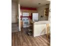 Cozy kitchen with modern appliances, wood cabinets, laminate flooring, and a breakfast bar at 4010 San Gallo Dr # 105, Kissimmee, FL 34741
