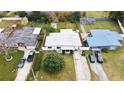 This is an aerial view of the home, its driveway and lawn and the neighboring houses at 4126 Montrose Ct, Orlando, FL 32812