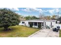 Cozy home featuring a lawn, mature tree, and a screened-in porch at 4126 Montrose Ct, Orlando, FL 32812