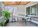 Enclosed porch with tiled floor, wood ceiling, views, and inviting seating area at 4126 Montrose Ct, Orlando, FL 32812
