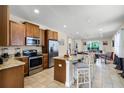 Modern kitchen featuring an island with seating, stainless steel appliances, and granite countertops at 561 Lasso Dr, Kissimmee, FL 34747