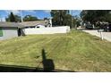Spacious yard with a view of a white fence and neighboring homes, showcasing the outdoor space at 608 S Lakeview Ave, Winter Garden, FL 34787