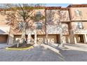 Beautiful townhome exterior with private garages and stone accents at 6109 Metrowest Blvd # 105, Orlando, FL 32835