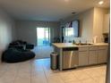 Bright living room featuring tile floors, a ceiling fan, and a sliding glass door at 735 Chinoy Rd, Davenport, FL 33837