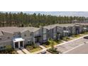 Community shot displaying townhomes with private parking and green spaces at 750 Pebble Beach Dr, Davenport, FL 33896