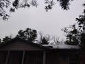 Heavily damaged roof covered in tarp, showing exterior damage and potential water issues at 800 Nicole Blvd, Ocoee, FL 34761