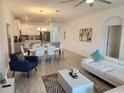 Bright living area with tile flooring and a spacious layout connects the kitchen, dining, and lounge spaces at 8885 Cabot Cliffs Dr # 103, Davenport, FL 33896