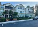 Well-maintained condo building with landscaping, a black iron fence, and reserved parking spots at 11446 Jasper Kay Ter # 106, Windermere, FL 34786