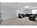 Open-concept living area featuring neutral walls, plush carpeting, with ample seating and natural light at 1669 Swan Swim Dr, Davenport, FL 33837