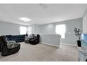 Spacious living room with plush carpeting, a modern ceiling fan, and comfortable seating for Gathering and friends at 1669 Swan Swim Dr, Davenport, FL 33837