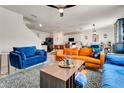 Open concept living room showcasing multiple sofas, modern decor, and an island with barstool seating at 1755 Buckeye Rd, Davenport, FL 33837