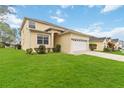 Beautifully landscaped yard with green grass surrounding this appealing home at 238 N Hampton Dr, Davenport, FL 33897