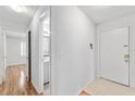 Bright hallway leading to a bathroom and the front door at 2424 Barley Club Ct # 8, Orlando, FL 32837