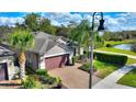 Charming single-Gathering home features a paver driveway, two car garage and tropical landscaping at 246 Tomelloso Way, Davenport, FL 33837
