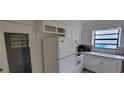 Bright kitchen featuring white appliances, ample cabinet space, and a window over the sink at 332 Carolina Ave, St Cloud, FL 34769