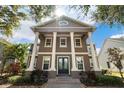 Grand two-story home featuring impressive white pillars and well-manicured landscaping at 3329 Schoolhouse Rd, Harmony, FL 34773