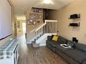 Comfortable living room featuring a staircase, hardwood floors, and media center at 3491 Allegra Cir, St Cloud, FL 34772