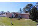 Charming single-story home featuring manicured lawn and mature trees at 350 Chelmsford Ct, Kissimmee, FL 34758