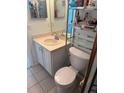 Well-lit bathroom featuring a modern vanity, toilet, and convenient storage shelves for toiletries at 466 Club Dr, Winter Springs, FL 32708