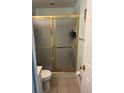Bathroom with a gold-framed shower, light tile flooring, and neutral walls for a clean aesthetic at 466 Club Dr, Winter Springs, FL 32708
