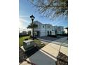 A street view highlighting the well-maintained townhomes, sidewalks, and green spaces within the community at 4740 Tribute Trl, Kissimmee, FL 34746