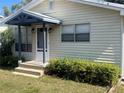 Inviting single-story home featuring a covered porch, neat landscaping, and a welcoming front entrance at 521 Tennessee Ave, St Cloud, FL 34769