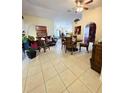 Open-concept living room and dining area with tile flooring and neutral wall colors at 5674 Sycamore Canyon Dr, Kissimmee, FL 34758