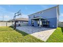 Spacious backyard with brick patio, outdoor fireplace, and basketball hoop for outdoor enjoyment at 580 Seattle Slew Dr, Davenport, FL 33837