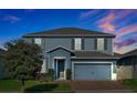 Charming two-story home with a two-car garage and well-manicured lawn at 580 Seattle Slew Dr, Davenport, FL 33837