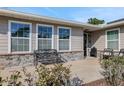 Inviting front porch with stone accents, comfortable seating, and a charming garden at 6845 Old Melbourne Hwy, St Cloud, FL 34771