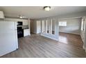 Open floor plan with kitchen and living room featuring modern vinyl flooring at 708 Se Pine Ave, Fort Meade, FL 33841