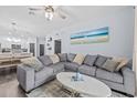Comfortable living room featuring a large sectional sofa and modern décor at 7671 Comrow St # 303, Kissimmee, FL 34747