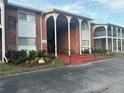 Exterior of building with unique arched entrance and brick facade at 777 W Lancaster Rd # A-13, Orlando, FL 32809