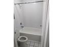 Cozy bathroom with white tiles, toilet, and a shower-tub combo at 7900 S Orange Blossom Trl # 1039, Orlando, FL 32809