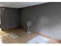 Empty living area with tiled flooring and a portable fan, awaiting your personal touch and decor at 7900 S Orange Blossom Trl # 2075, Orlando, FL 32809