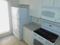 Bright kitchen with white appliances, granite-style countertops, and ample cabinet space at 84 Silver Park Cir, Kissimmee, FL 34743