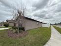 Side view of a well-maintained home, showcasing the clean landscaping and spacious yard at 8835 Conway Rd, Polk City, FL 33868