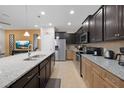 Spacious kitchen featuring granite countertops, stainless steel appliances, and dark wood cabinets at 8960 Adriatico Ln, Kissimmee, FL 34747
