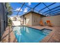 Private screened-in pool area featuring lounge chairs and a calming, bright blue pool at 8960 Adriatico Ln, Kissimmee, FL 34747