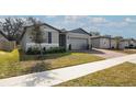 Charming single-story home with well-manicured lawn and brick paver driveway at 956 Cambridge Dr, Winter Haven, FL 33881