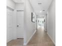 Bright hallway with light wood-look flooring at 956 Cambridge Dr, Winter Haven, FL 33881