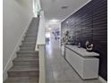 Modern hallway with decorative wall panel, console table and stylish decor at 1292 Cascades Ave, Davenport, FL 33837