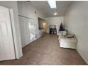 Open concept living room with tile floors, high ceilings, and natural light from the sky light at 1324 Eagle Ln, Winter Garden, FL 34787